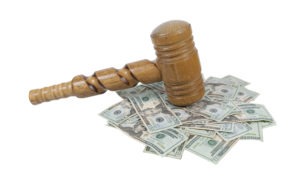 Super Sized Wooden Gavel on a Pile of Money